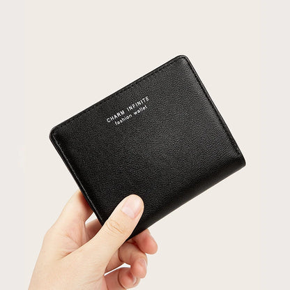 Black wallet held by a hand with 'CHARM INFINITE' branding