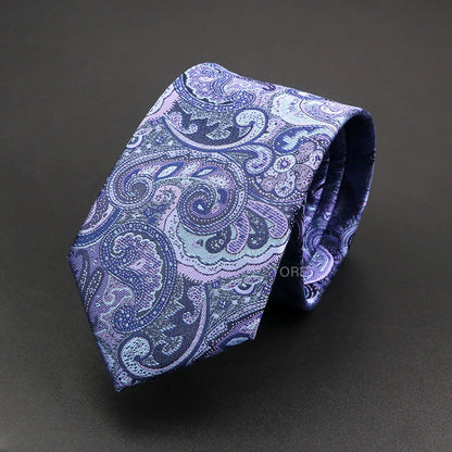 Blue paisley patterned tie on a dark background