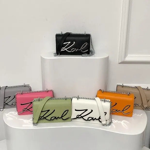 Collection of CaRaUaNa Karl Clutch Bag in various colors on a white surface.