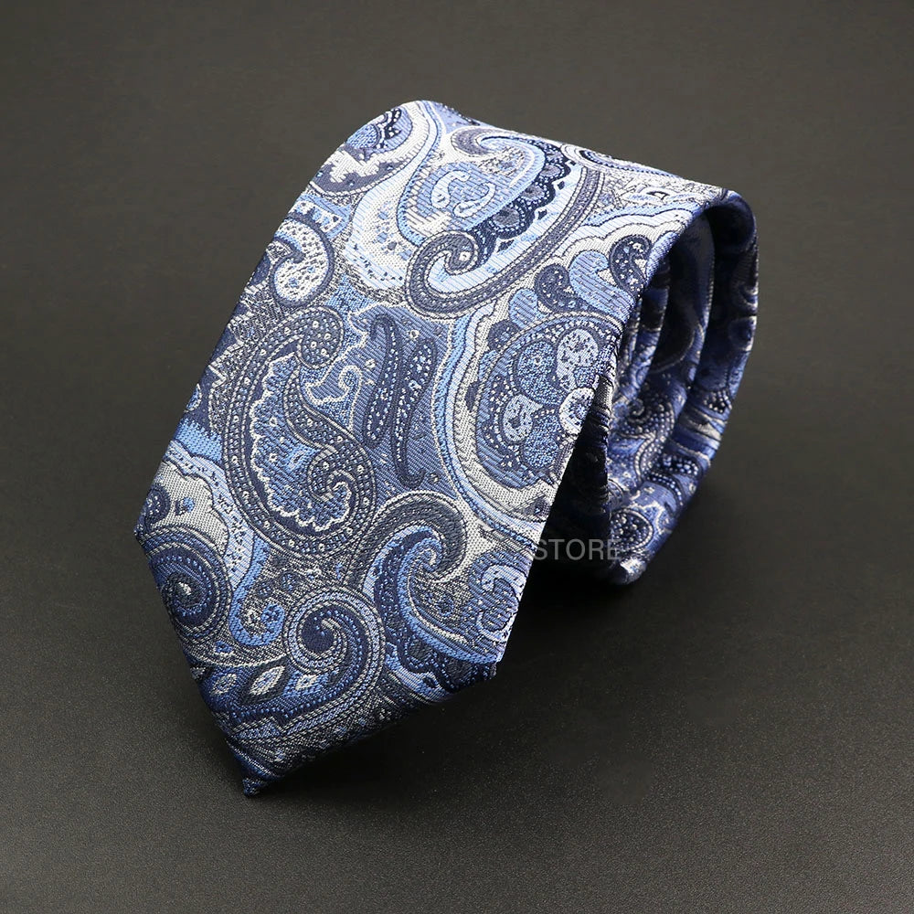 Blue paisley patterned tie on a dark gray background