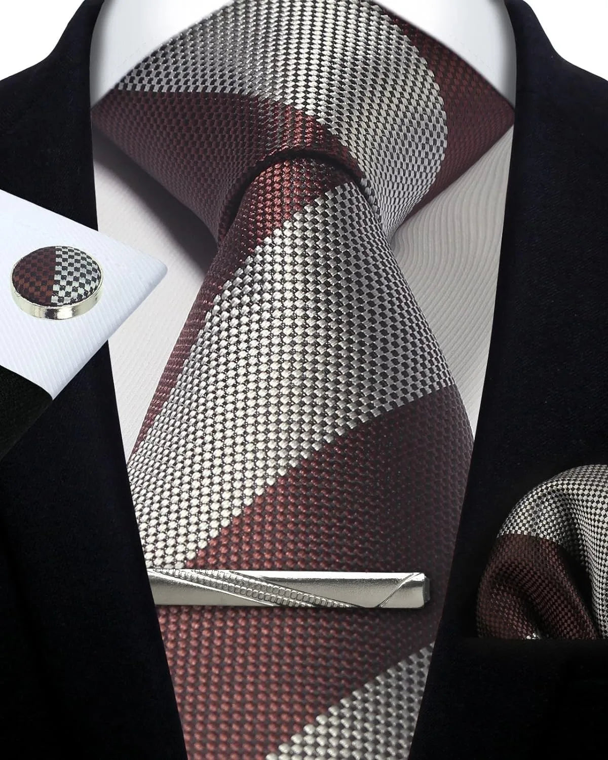 Patterned tie with matching pocket square and cufflinks on a mannequin.