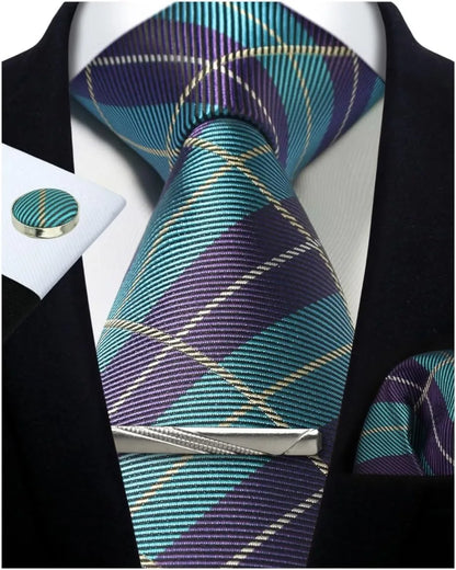 Plaid tie with matching pocket square and cufflinks on a black suit jacket.