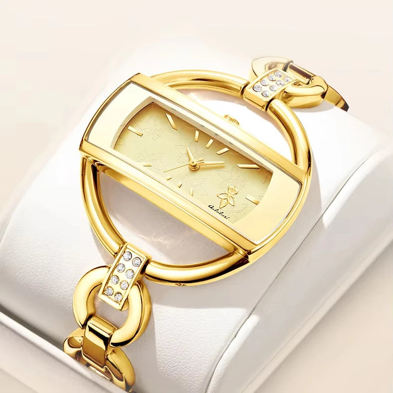 Gold wristwatch with decorative chain.